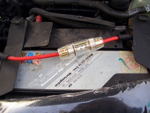v4awgbatteryconnection.JPG - I used 60 amp AWG cable and a fuse directly from the main battery to the rear of the car. I was able to find a good ground from the rear light cluster